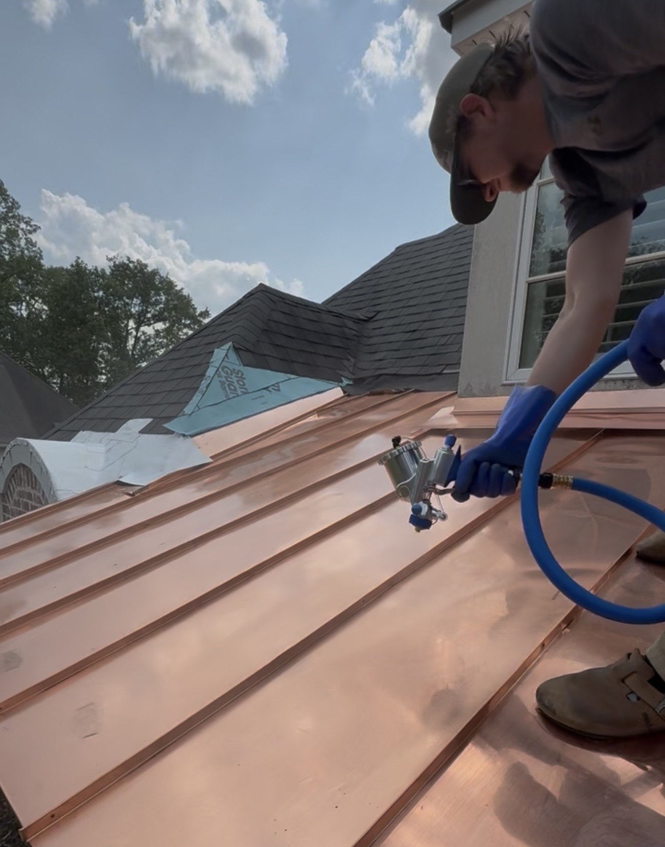Applying Everbrite to copper roof with HVLP spray rig