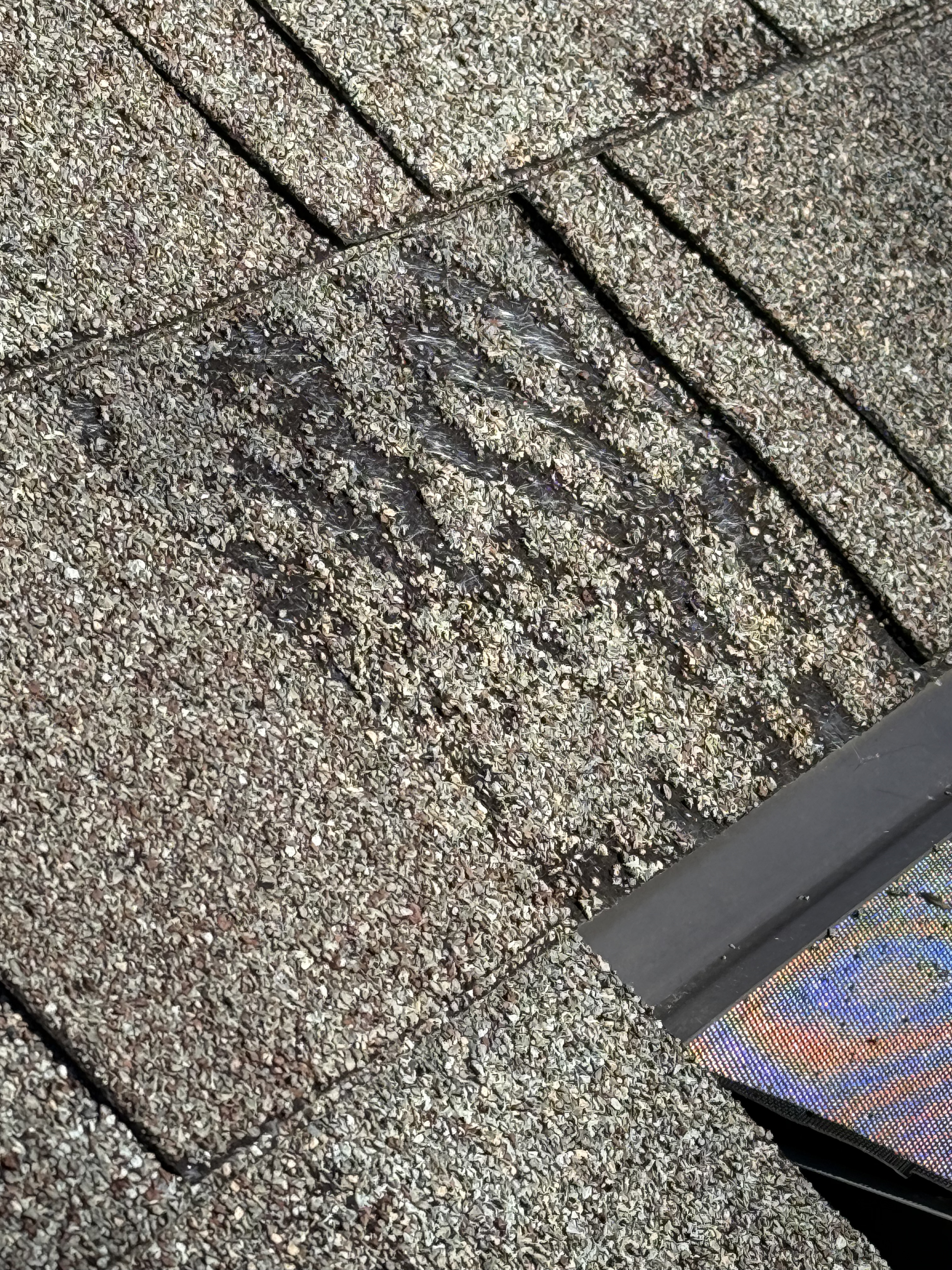 Close-up showing exposed asphalt on bottom layer